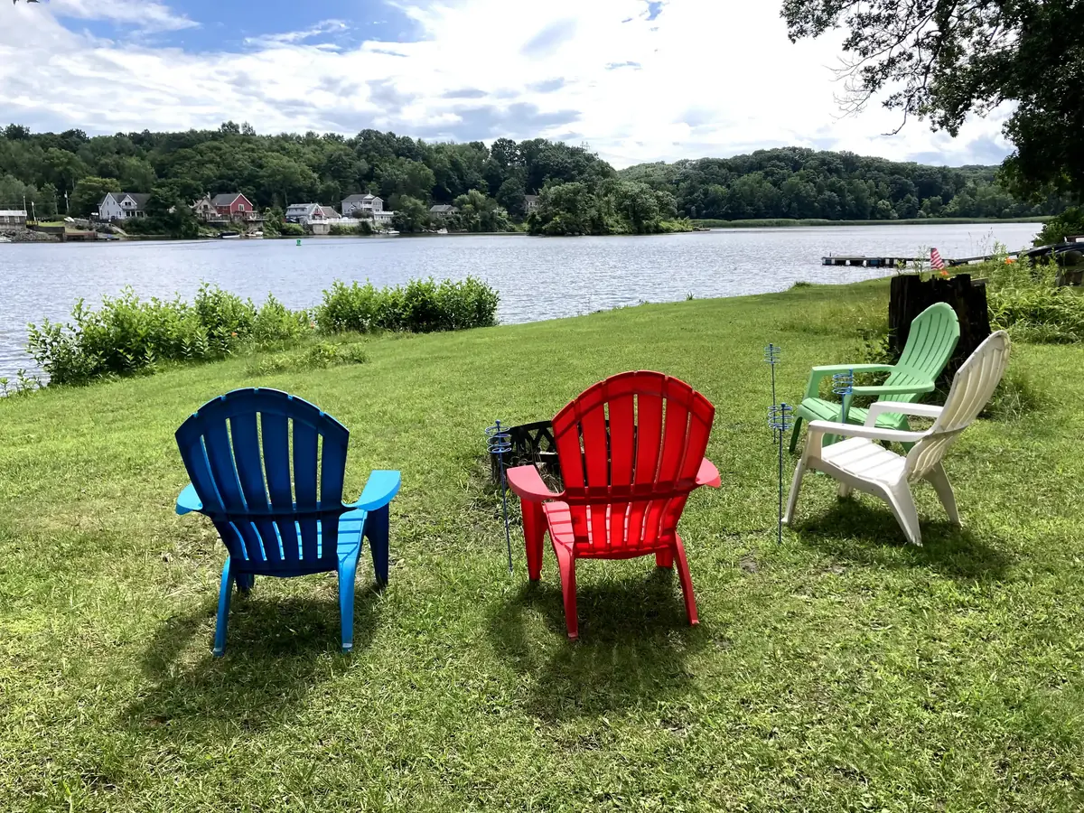 Adirondack chairs on the lawn above the Mohawk River at Towpath Landing