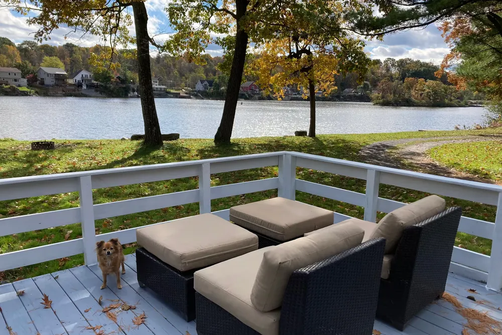 Porch seating overlooking the river at Cabin 9